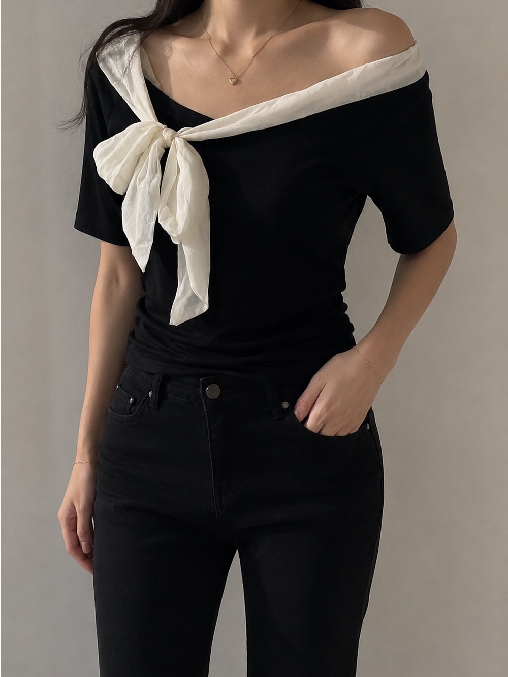 Minimalist Black Off-Shoulder Top with White Bow Detail